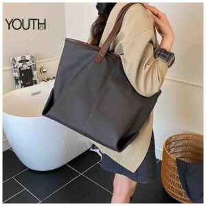 this is a bag on model photo for a dark gray canvas tote bag style#yt0099