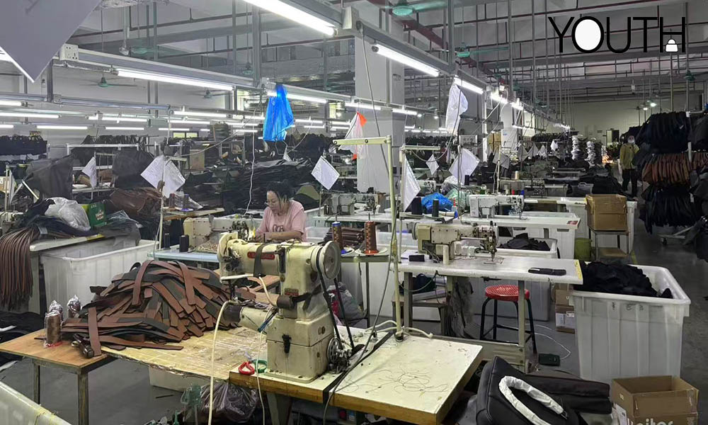 A photo showing a bag factory with workers in sewing