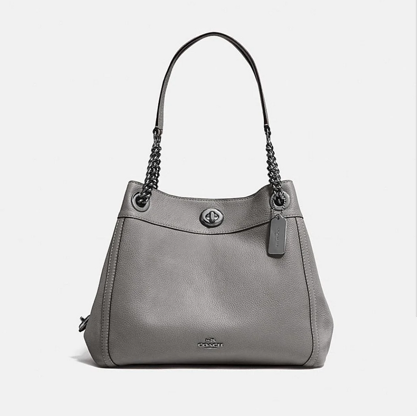 A front view of a grey coach edie leather shouder bags