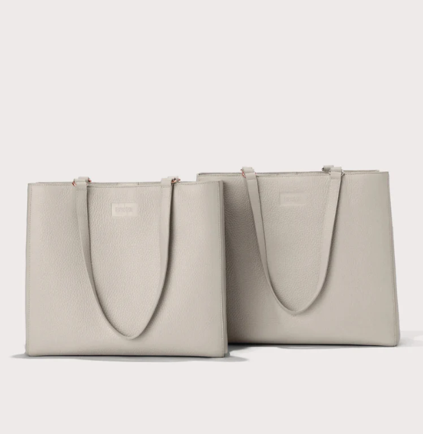 A front view of two beige dagne dover allyn tote bags sitting together