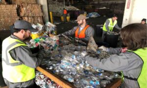 4 workers are processing wasted bottles in the mill t