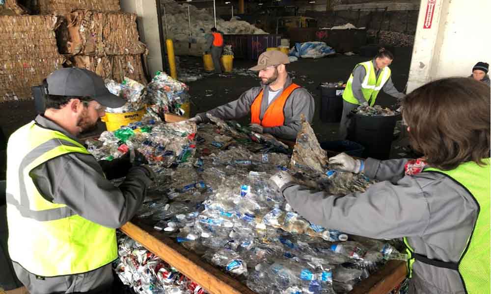 4 workers are processing wasted bottles in the mill t