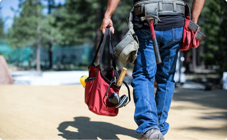 A man in blue denim pant holding a Mina Baie Juliet Work Tote on the way as featured photo