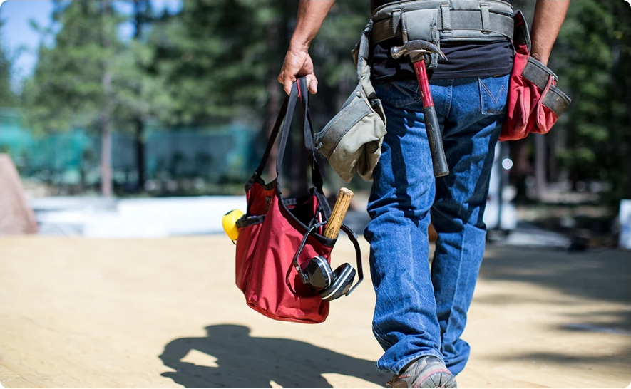 A man in blue denim pant holding a Mina Baie Juliet Work Tote on the way as featured photo