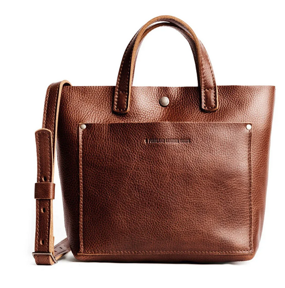 A front view of a brown portland leather tote bag with straps